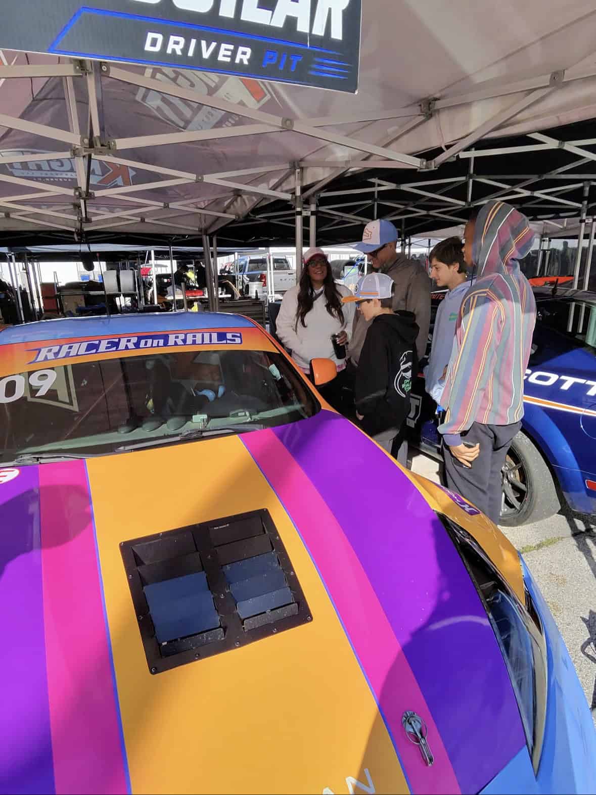 Fans checking out the #109 in the paddock after the race