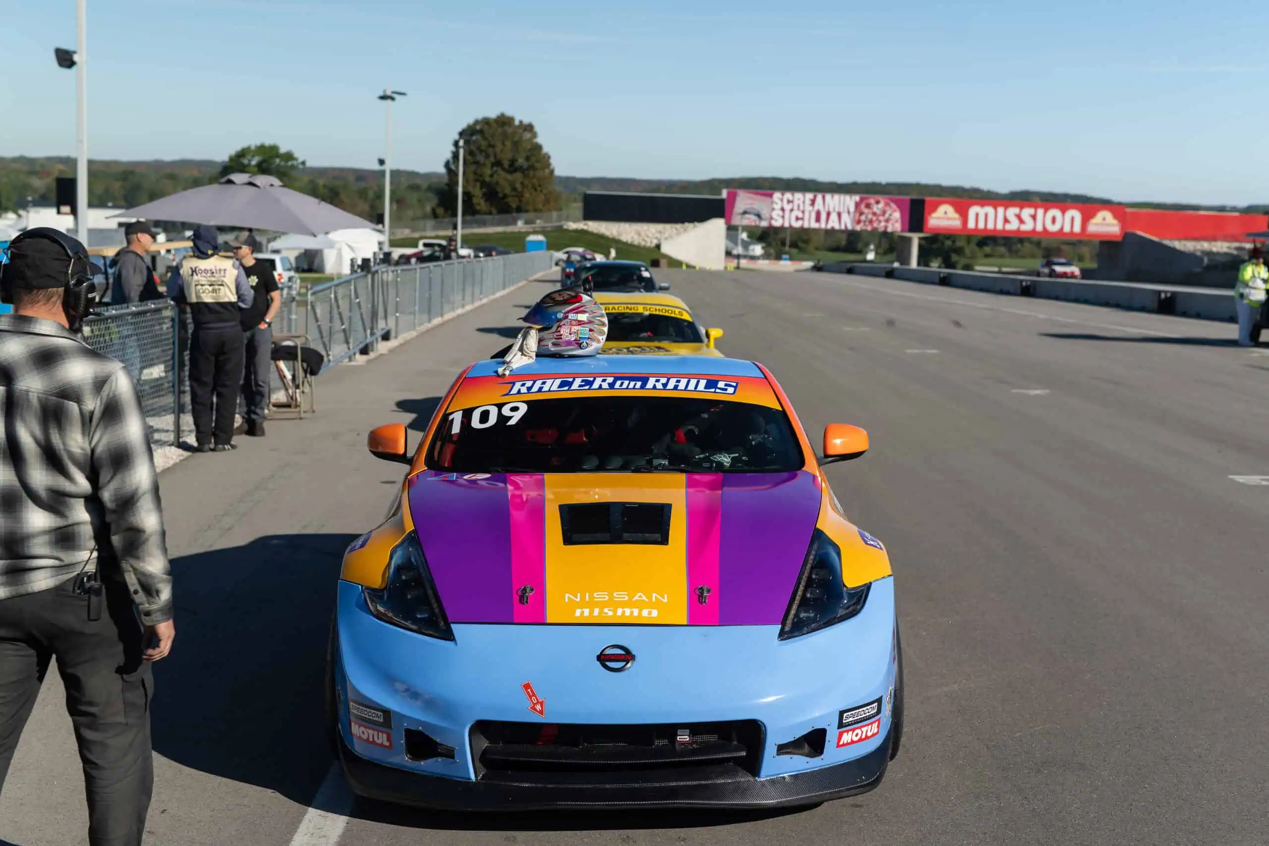 #109 370Z head-on in the paddock with its fresh wrap